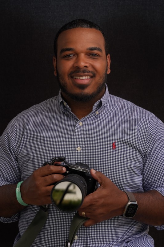 Stew, the creator behind TainoZ, holding a camera